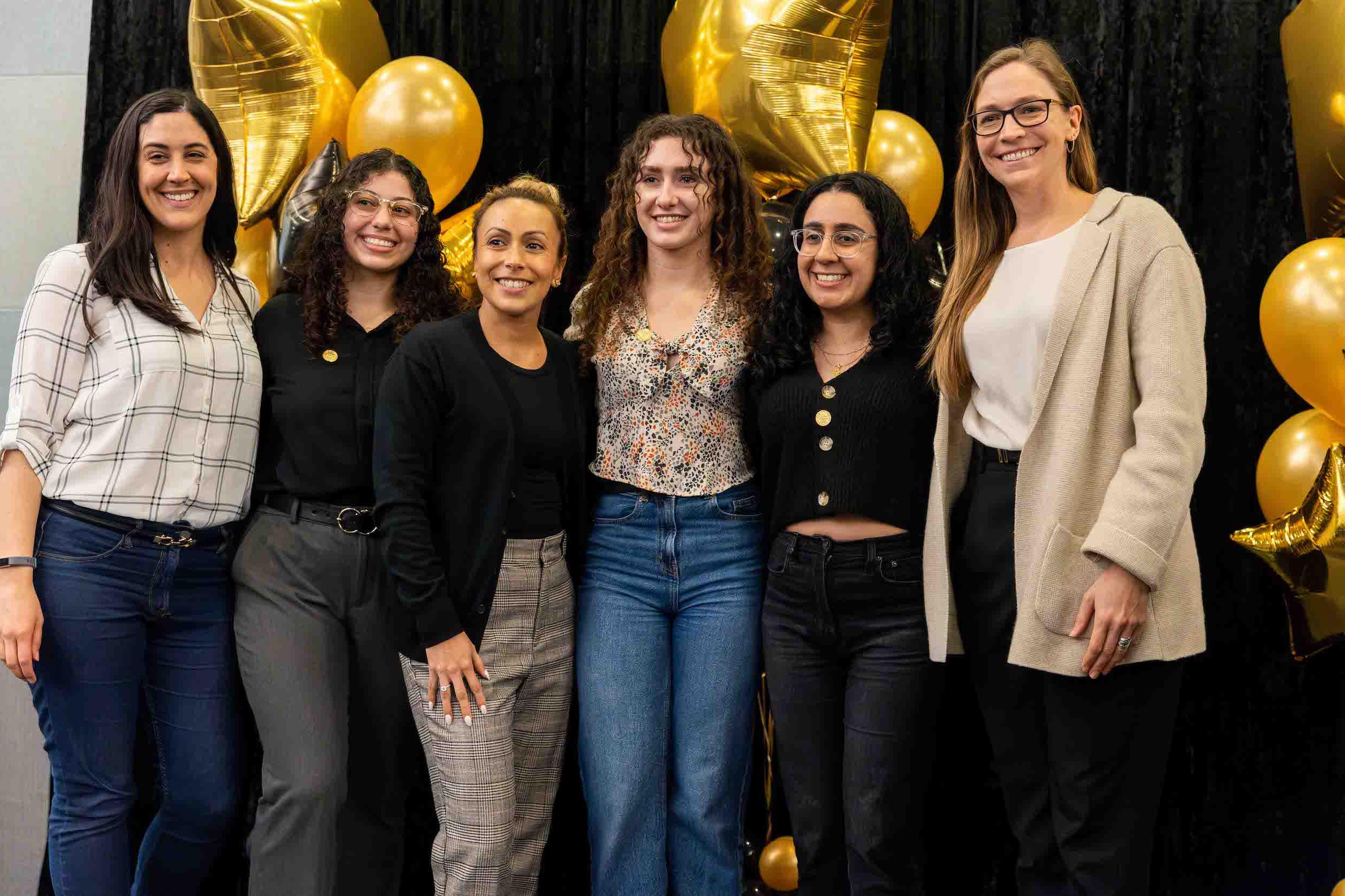 Group of students pose with their professors