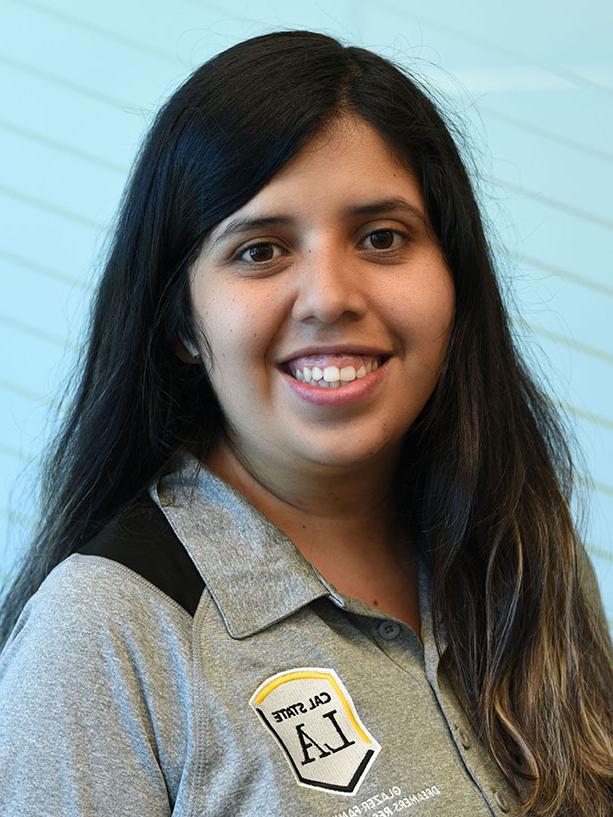 A person with long hair smiling