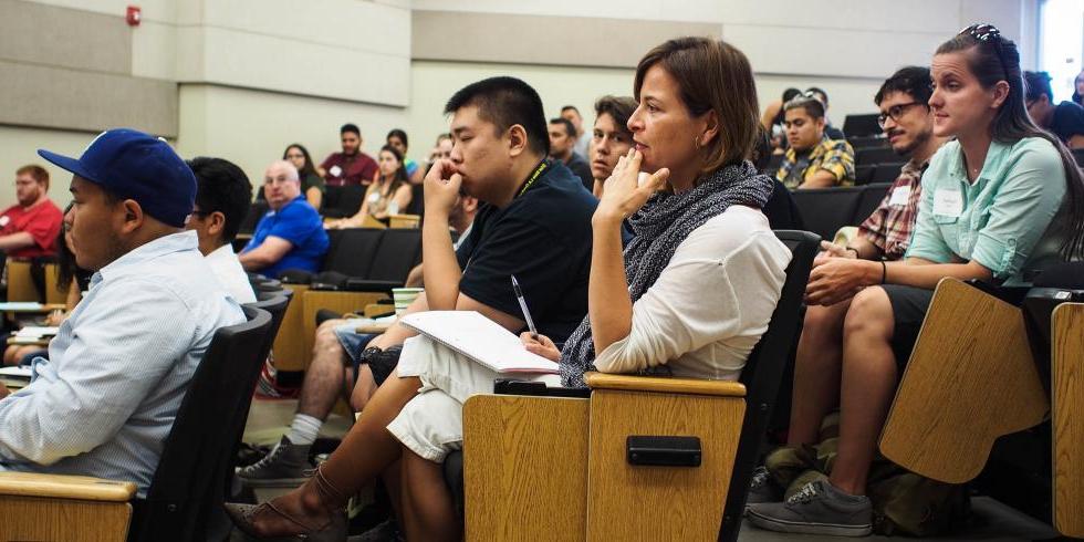 Students listening to orientation speakers in Rosser Hall lecture hall