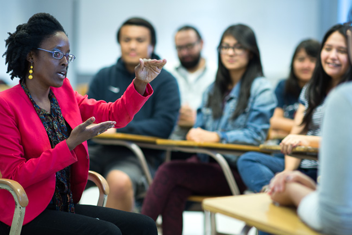 students seated in circle advising 