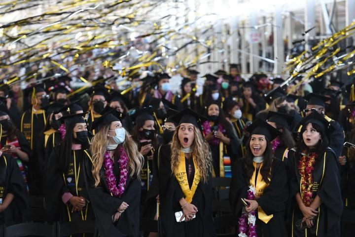 Students smiling at commencement.