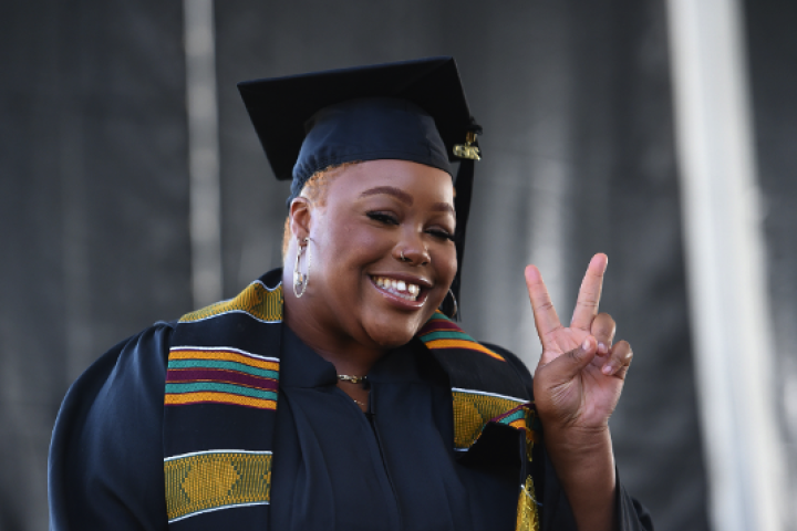 Cal State LA Student at Graduation showing Peace Sign