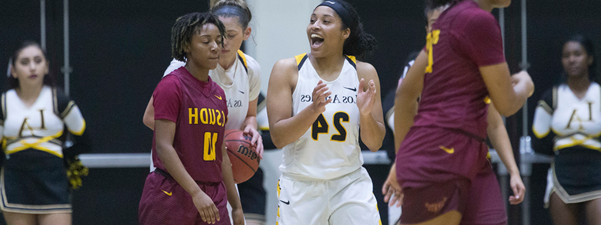 Image of the Cal State LA women's basketball team on the court mid-game. 