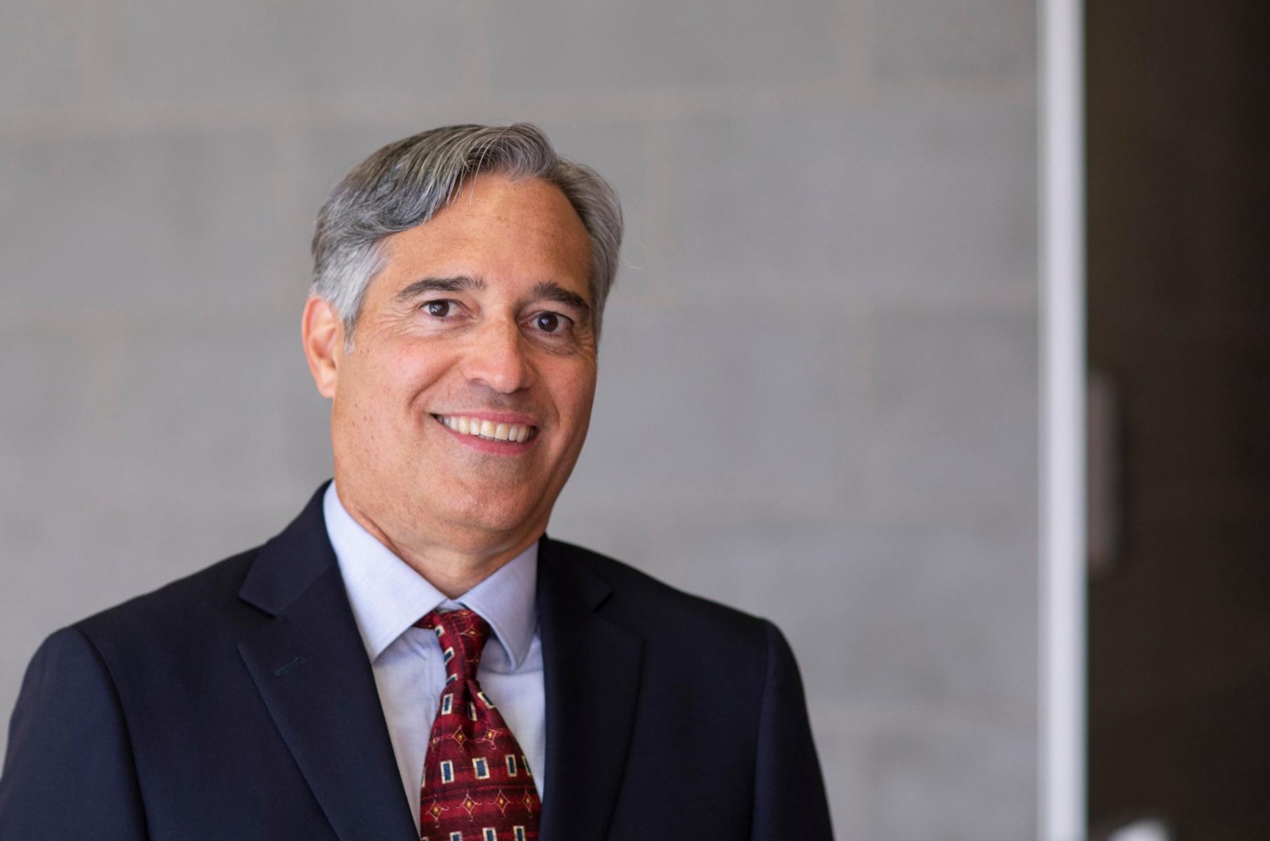 Man with red tie and dark blue suit 